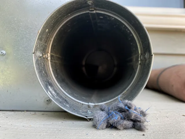 Lakewood Dryer Vent Cleaning technician using specialized equipment to clear severe dryer vent blockage in Lakewood